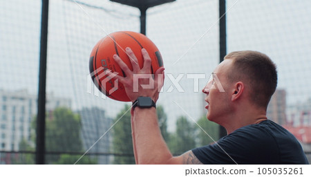 Close up man handling a ball, throwing and scoring on basketball court. Healthy lifestyle and sport concept. 105035261