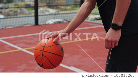 Close up man handling a ball, throwing and scoring on basketball court. Healthy lifestyle and sport concept. 105035263