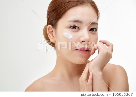 beautiful young woman with clean skin and moisturizing cream beautiful young woman with clean skin and moisturizing cream 105035367