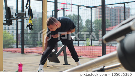 Man warming up before training at sport ground. Physical training. Healthy lifestyle. Man warming up before training at sport ground. Physical training. Healthy lifestyle. 105035390