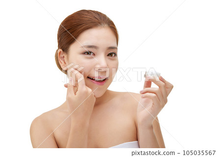 beautiful young woman with clean skin and moisturizing cream beautiful young woman with clean skin and moisturizing cream 105035567