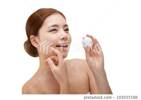 beautiful young woman with clean skin and moisturizing cream 105035586