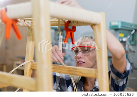 Female worker working furniture at manufacturing wooden industry. Female worker working furniture at manufacturing wooden industry. 105035626