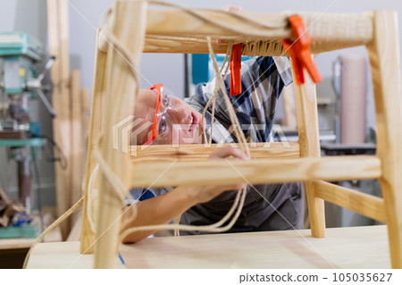 Female worker working furniture, table, chair at manufacturing wooden industry. Female worker working furniture, table, chair at manufacturing wooden industry. 105035627