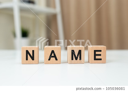 Word NAME on wooden cube block. Alphabet message NAME on table office. Letters in black Word NAME on wooden cube block. Alphabet message NAME on table office. Letters in black 105036081