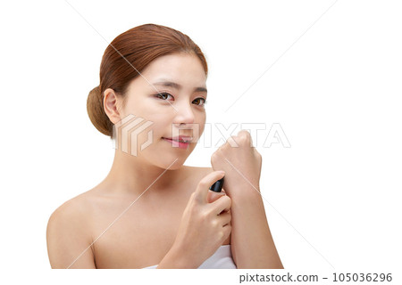 portrait of a young woman taking care of her skin portrait of a young woman taking care of her skin 105036296