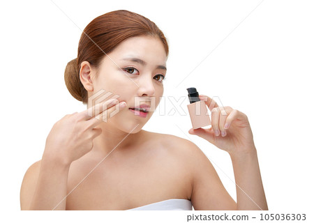 portrait of a young woman taking care of her skin 105036303