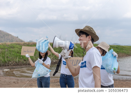 Group of volunteers holding rubbish bags and sign to campaign to save the global environment. Group of volunteers holding rubbish bags and sign to campaign to save the global environment. 105036473