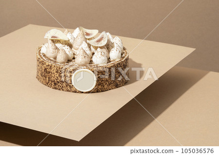 A scrumptious desert plate featuring a meringue desert, served on a cardboard plate and topped with cream A scrumptious desert plate featuring a meringue desert, served on a cardboard plate and topped with cream 105036576