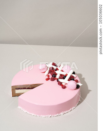 A close-up shot of a delectable cake featuring a raspberry and white chocolate topping A close-up shot of a delectable cake featuring a raspberry and white chocolate topping 105036602