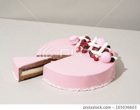 A close-up shot of a delectable cake featuring a raspberry and white chocolate topping 105036603