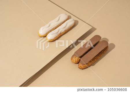 A set of delicious glazed donuts in a variety of flavors, arranged on a cardboard paper in an inviting display A set of delicious glazed donuts in a variety of flavors, arranged on a cardboard paper in an inviting display 105036608