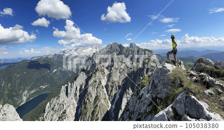 Female climber on a via ferrata - climbing on a rock in Austria Alps 105038380