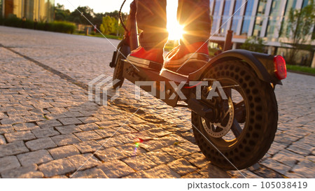 electric mobility scooter rider, man ride sharing or rent personl eco transportation electric mobility scooter rider, man ride sharing or rent personl eco transportation 105038419