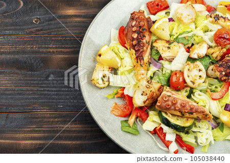 Seafood salad with octopus tentacles. 105038440
