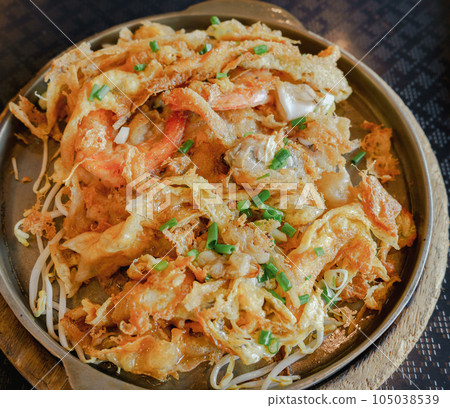 Fried shrimp with vermicelli in a plate on wooden table Fried shrimp with vermicelli in a plate on wooden table 105038539