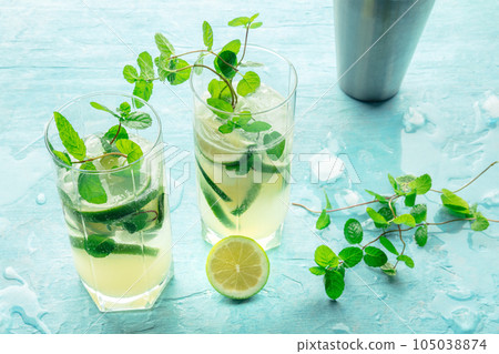 Mojito cocktail. Summer cold drink with lime, fresh mint, and ice. Cool beverage 105038874