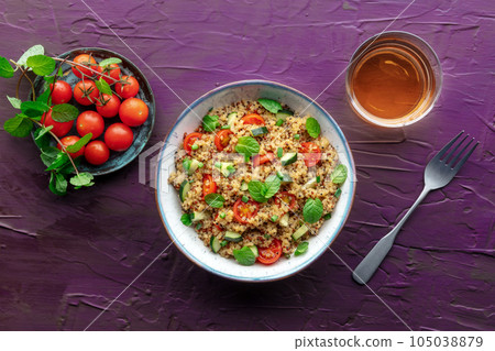 Quinoa tabbouleh salad in a bowl, a healthy dinner with tomatoes and mint 105038879