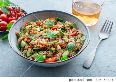Quinoa tabbouleh salad in a bowl, a healthy dinner with tomatoes and mint 105038883