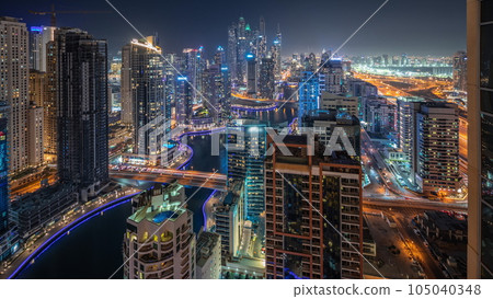 Panorama showing various skyscrapers in tallest recidential block in Dubai Marina aerial night timelapse 105040348
