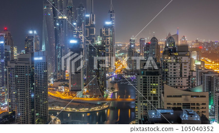 View of various skyscrapers in tallest recidential block in Dubai Marina aerial all night timelapse 105040352