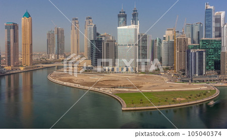 Cityscape skyscrapers of Dubai Business Bay with water canal aerial timelapse. 105040374