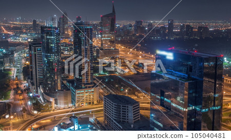 Aerial view of media city and al barsha heights district area all night timelapse from Dubai marina. Aerial view of media city and al barsha heights district area all night timelapse from Dubai marina. 105040481