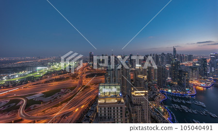Dubai marina and JLT skyscrapers along Sheikh Zayed Road aerial day to night timelapse. Dubai marina and JLT skyscrapers along Sheikh Zayed Road aerial day to night timelapse. 105040491