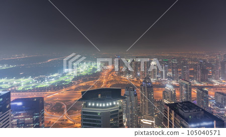 Panorama of Dubai Marina with JLT skyscrapers and golf course night timelapse, Dubai, United Arab Emirates. Panorama of Dubai Marina with JLT skyscrapers and golf course night timelapse, Dubai, United Arab Emirates. 105040571