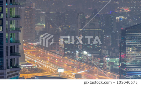 Dubai Aerial view showing al barsha heights and greens district area day to night timelapse Dubai Aerial view showing al barsha heights and greens district area day to night timelapse 105040573