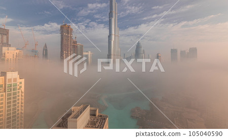 Aerial view of Dubai city early morning during fog timelapse. Aerial view of Dubai city early morning during fog timelapse. 105040590