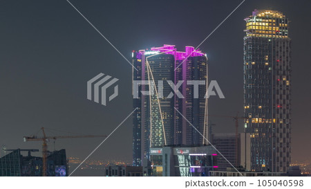 Skyscrapers at the Business Bay aerial day to night timelapse in Dubai, United Arab Emirates Skyscrapers at the Business Bay aerial day to night timelapse in Dubai, United Arab Emirates 105040598