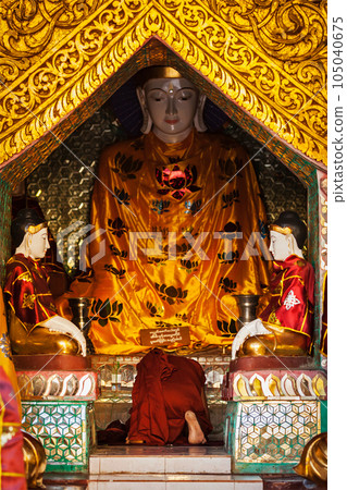 Buddhist monk praying in Shwedagon Paya pagoda. Yangon, Myanmar Buddhist monk praying in Shwedagon Paya pagoda. Yangon, Myanmar 105040675