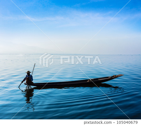 Myanmar travel attraction landmark - Traditional Burmese fisherman at Inle lake, Myanmar famous for their distinctive one legged rowing style 105040679