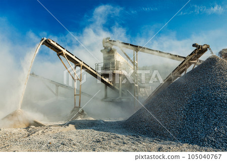 Industrial background - crusher rock stone crushing machine at open pit mining and processing plant for crushed stone, sand and gravel 105040767