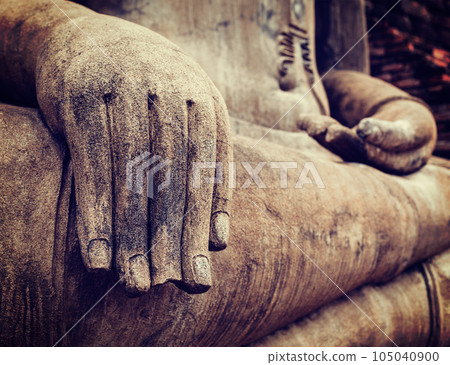 Vintage retro effect filtered hipster style travel image of Buddha statue hand close up detail. Sukhothai, Thailand 105040900