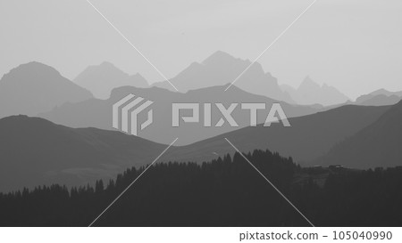 Monochrome image of mountain ranges in the morning light seen from Vorder Walig, Switzerland. Monochrome image of mountain ranges in the morning light seen from Vorder Walig, Switzerland. 105040990
