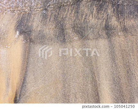 Beach wet sand texture. Sandy shore beige background. Beach wet sand texture. Sandy shore beige background. 105041250