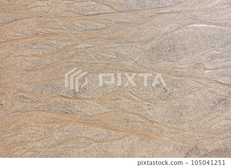 Beach wet sand texture. Sandy shore beige background. Beach wet sand texture. Sandy shore beige background. 105041251