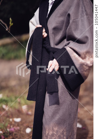 Beautiful young woman wearing kimono with cherry blossoms, sakura view Beautiful young woman wearing kimono with cherry blossoms, sakura view 105041447