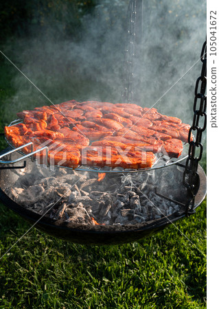Cooking tasty meat slices at bbq grill backyard Grilling tenderloin on charcoal. steaks on the grill Cooking tasty meat slices at bbq grill backyard Grilling tenderloin on charcoal. steaks on the grill 105041672