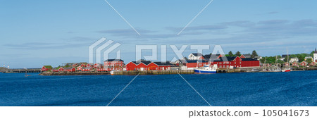 Summer in Reine, Lofoten Islands, Norway. Popular tourist destination. Old fishermans village with wooden red cottages Summer in Reine, Lofoten Islands, Norway. Popular tourist destination. Old fishermans village with wooden red cottages 105041673
