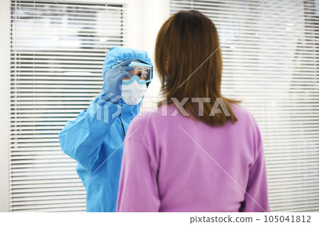 Nurse in personal protective equipment PPE doing PCR test to pregnant patient, taking nasal swab. Nurse in personal protective equipment PPE doing PCR test to pregnant patient, taking nasal swab. 105041812