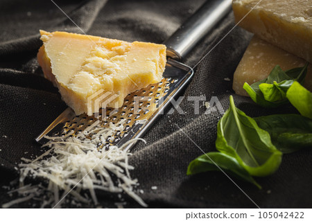 Tasty parmesan cheese. Grated cheese. Tasty parmesan cheese. Grated cheese. 105042422
