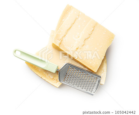 Tasty parmesan cheese and grater isolated on white background. Tasty parmesan cheese and grater isolated on white background. 105042442