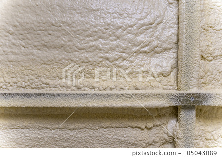 Close-up of the walls of the building insulated with polyurethane foam Close-up of the walls of the building insulated with polyurethane foam 105043089