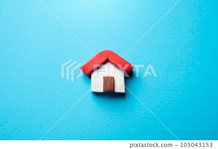 Miniature house on a blue background. Buying and selling housing. Real estate market review. Construction industry. Design and architectural services. Property insurance. 105043153