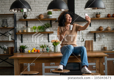 Cute woman with a phone in hands looking excited Cute woman with a phone in hands looking excited 105043673