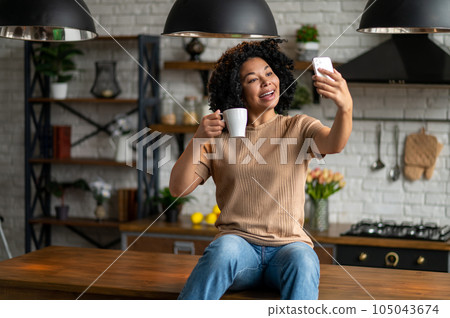 Cute woman with a phone in hands looking excited Cute woman with a phone in hands looking excited 105043674