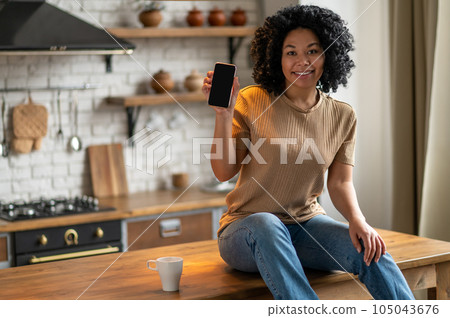 Cute woman with a phone in hands looking excited 105043676